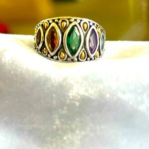 Silver ring with gold embellishments.